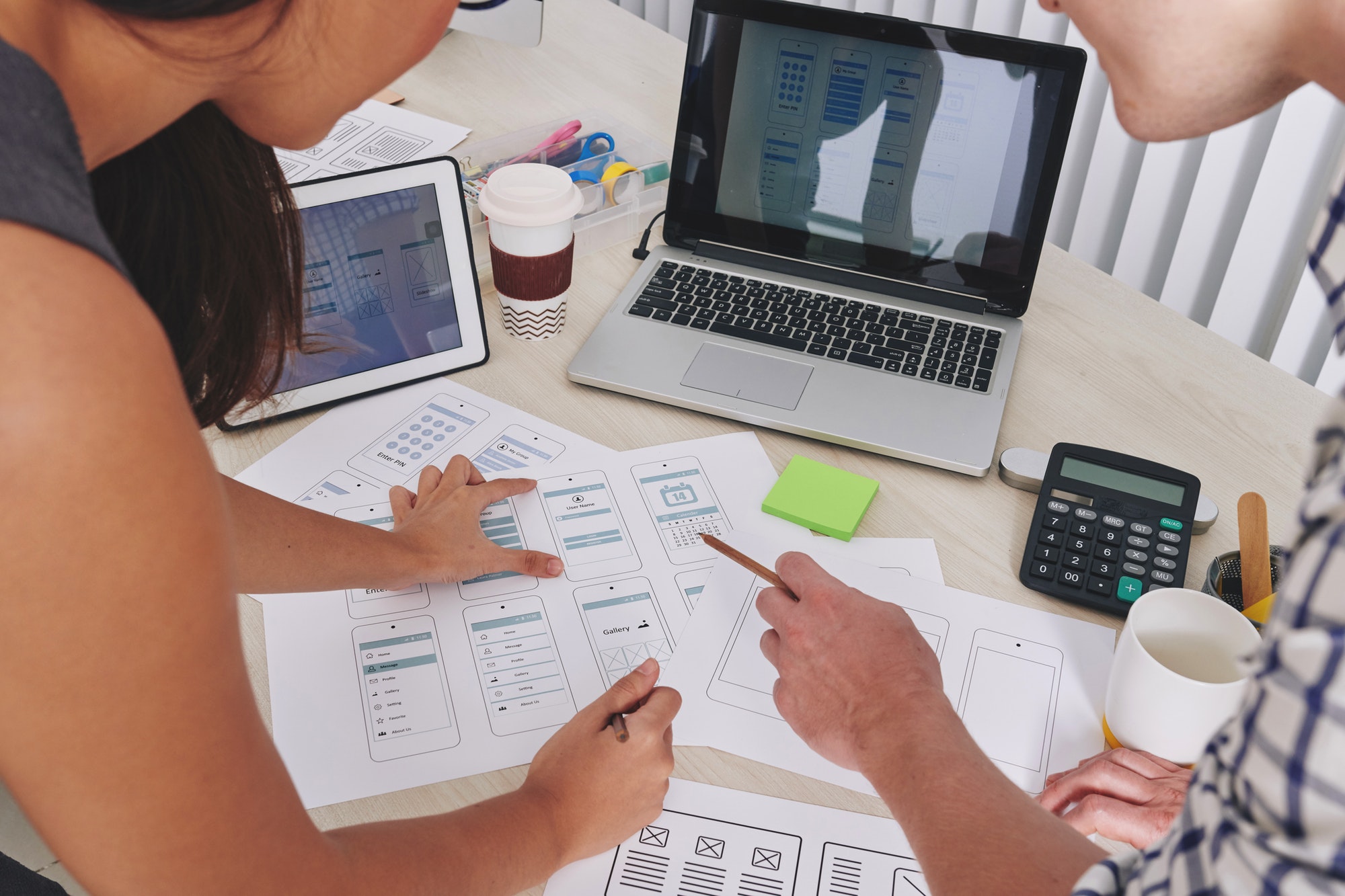 ux and ui designers discussing project